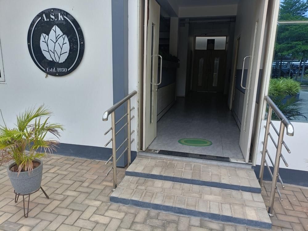 The A.S.K badge mounted beside the office entrance