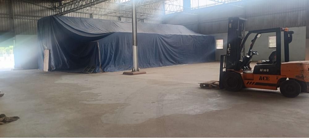 Forklift beside covered tobacco stacks in the warehouse