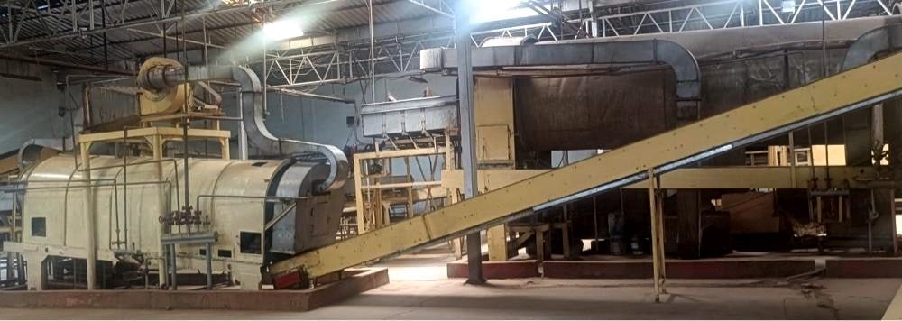 Conditioning cylinder and inclined feed conveyor on the processing line