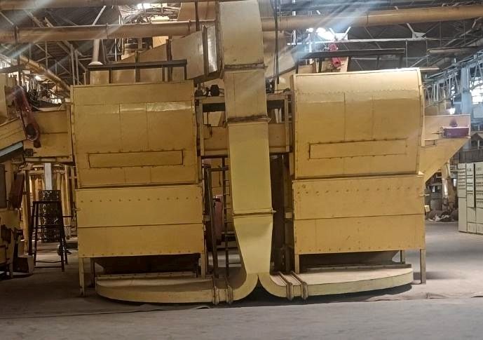 Two large threshing units connected by ducting on the processing line